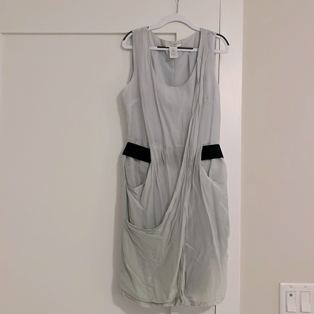 Linen sleeveless dress with elastic black belt and pockets. Hits above knee.